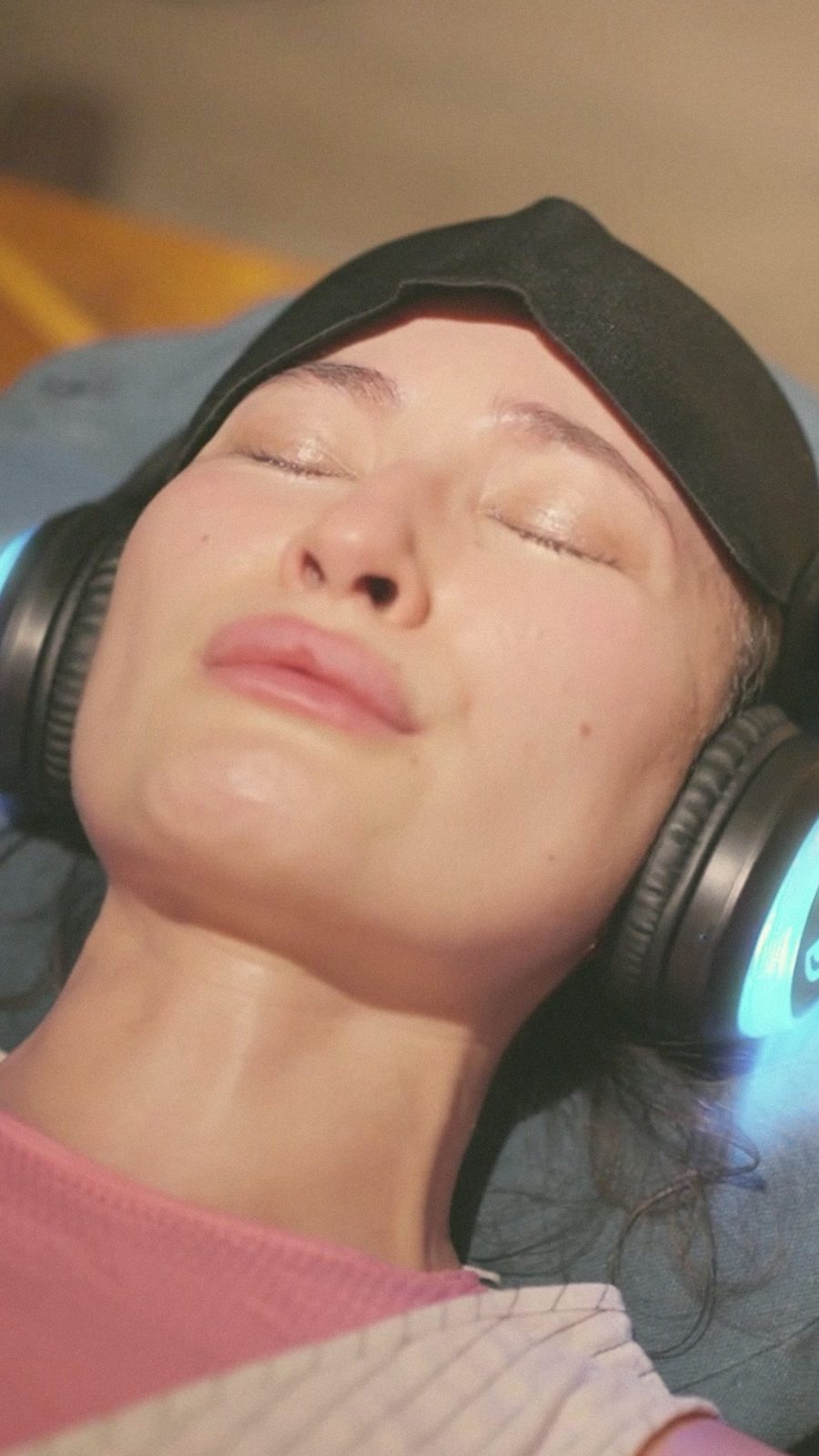 A person resting with eyes closed at a TerraPeeps session